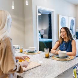 two women talking in a kitchen