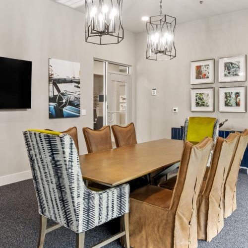 Enjoy our resident-only features a dining room table with chairs and a television in the background