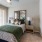 a bedroom with a bed and a mirror