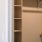 a white closet with a metal ladder