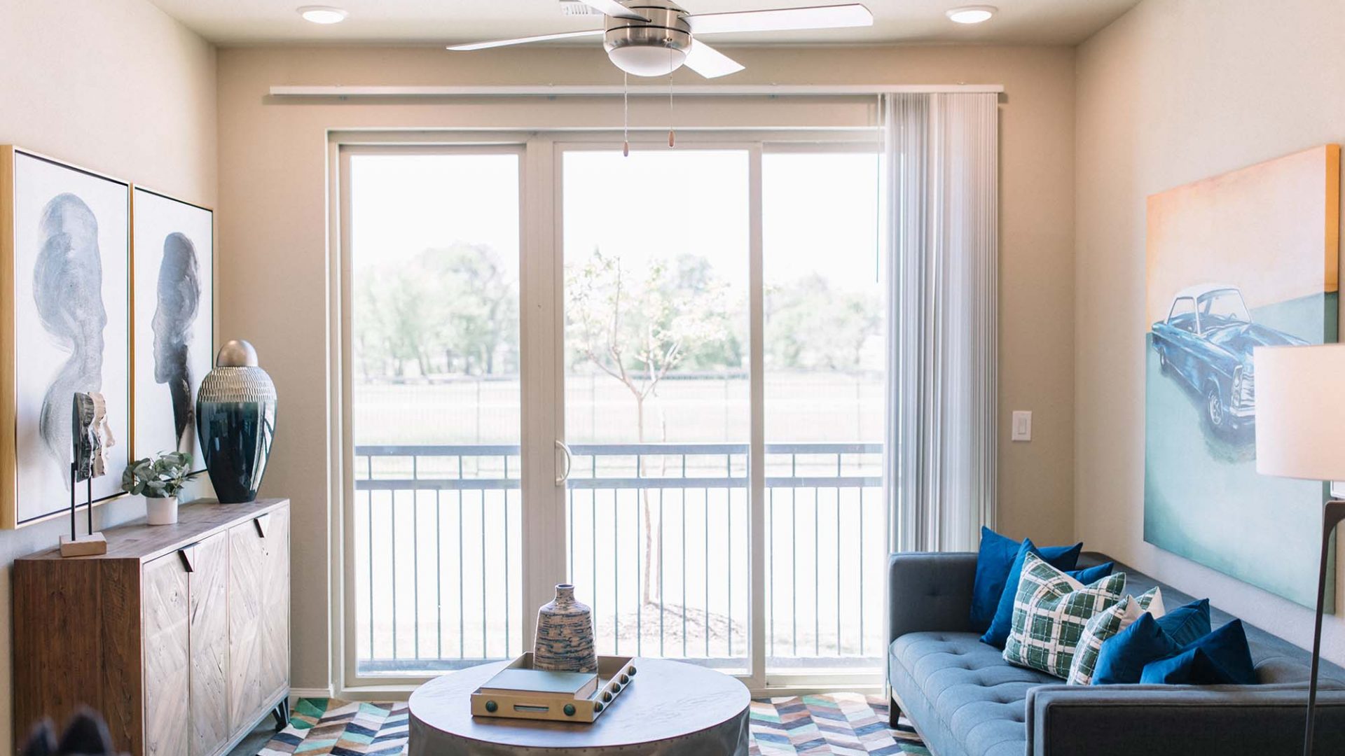 a living room with a ceiling fan and a couch at The Gates at Meadow Place in Willow Park Texas