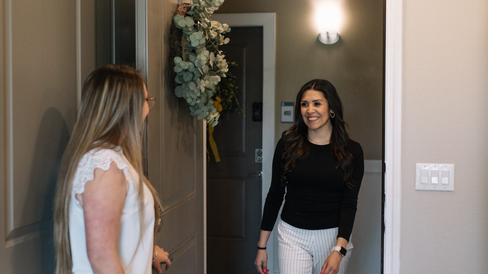 two women standing in front of a door at The Gates at Meadow Place