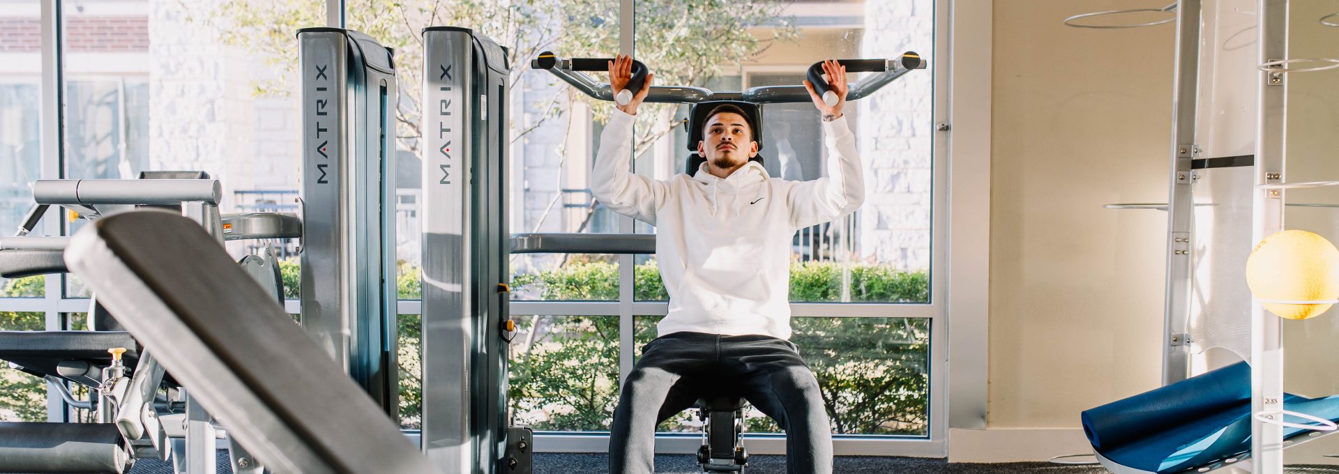 a woman doing a push up in a gym at The Gates at Meadow Place