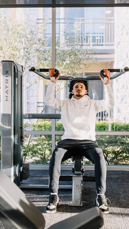 a woman doing a push up in a gym at The Gates at Meadow Place